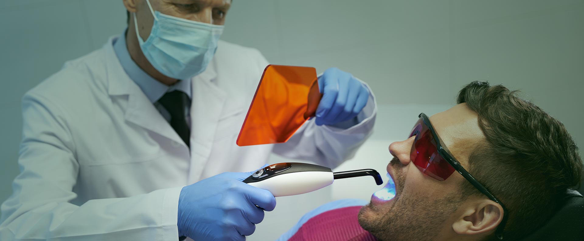 Man having laser dental treatment at the clinic