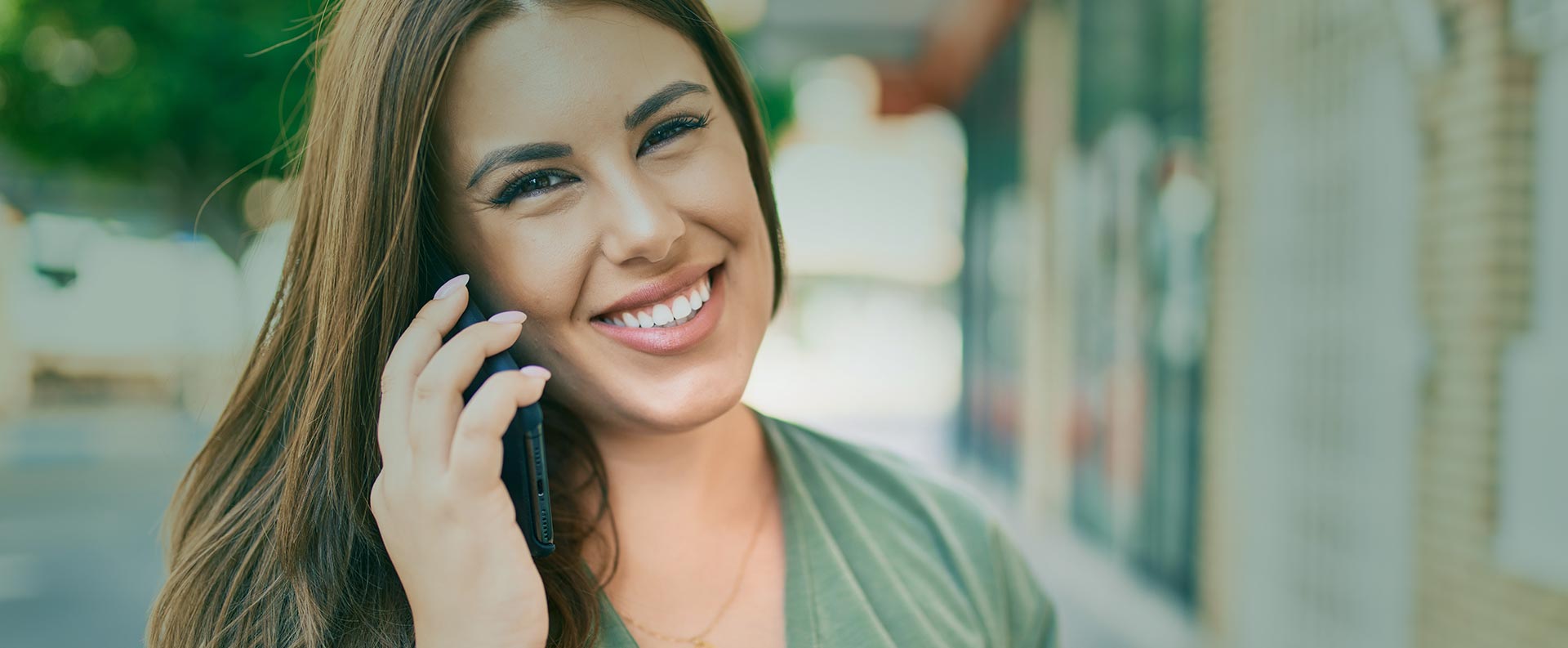 Woman answering phone call while smiling